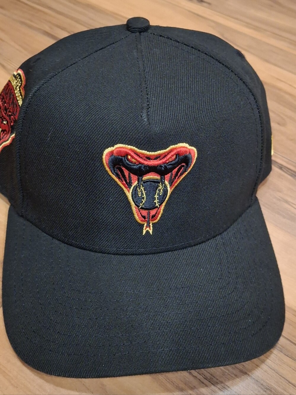 New Era Black Hat with Red and Yellow Snake Patch